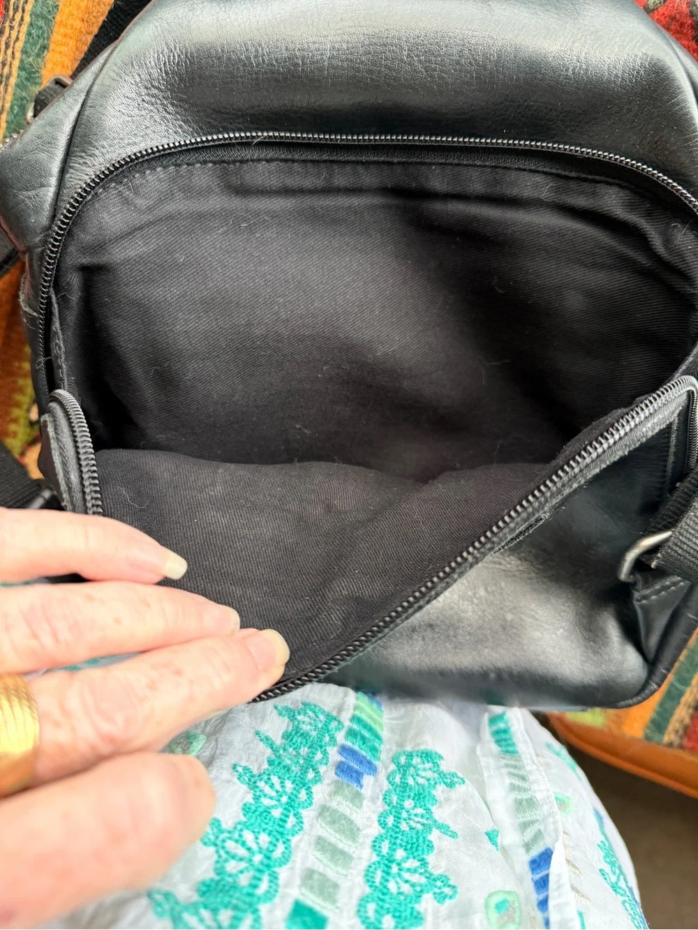 Black trianglular leather backpack with multiple pockets